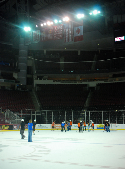 students playing broom ball on the ice