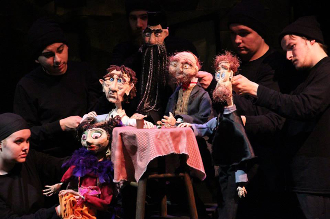 photo of students performing with puppets