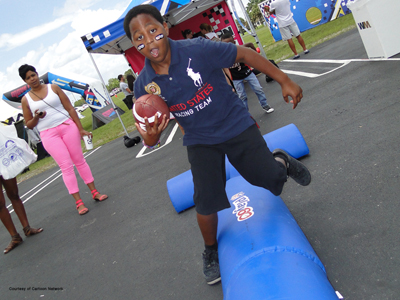 boy running with a football