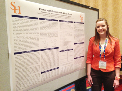 Paige Hinners in front of her research poster
