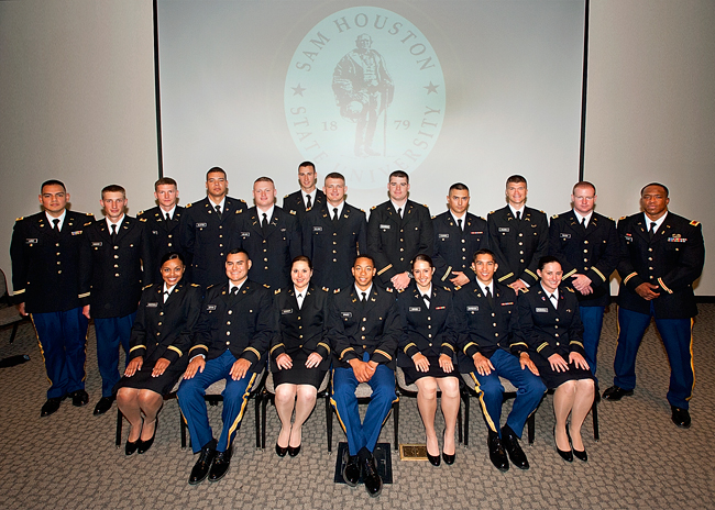 the SHSU seniors wearing their uniforms and posing for a picture at their Commissioning ceremony