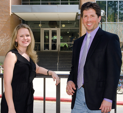 Cheryl Hudec and Gene Theodori posing in front of the CHSS building