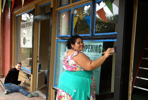 students painting the gallery exterior