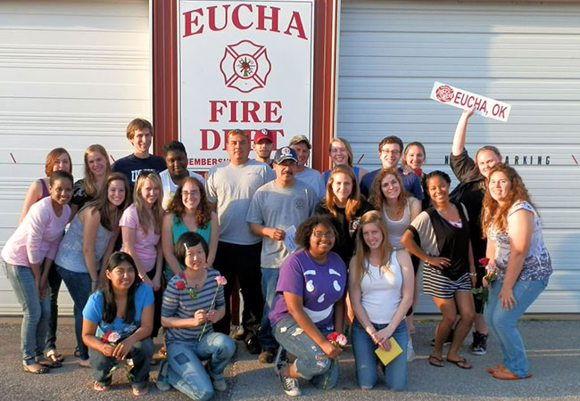 students and faculty posing in front of Eucha fire department