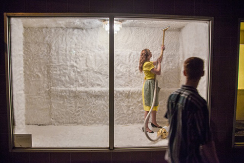 woman vaccuming the ceiling