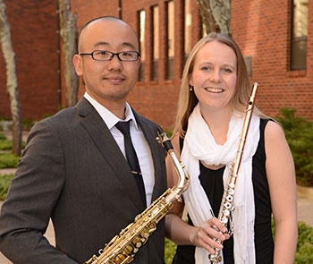 Mas Sugihara and Jennifer Brimson Cooper holding their instruments