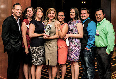 Crystal award winners posing with their award