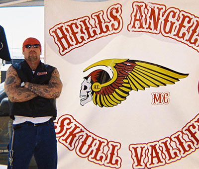 Dobyns in front of Hell's Angels banner