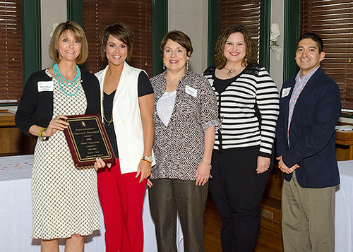 staff from Enrollment Management pose with their award plaque
