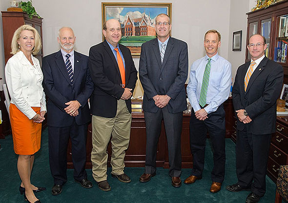 University President Gibson and Provost Hebert atanding with recipients of faculty excellence awards