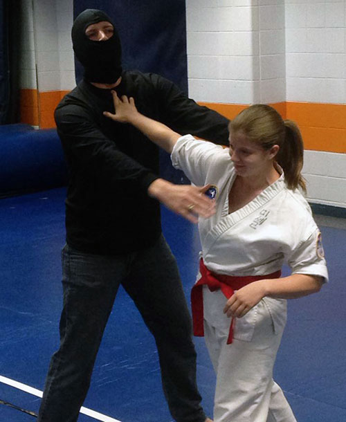 student practicing self defense in attack scenario