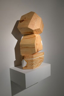 sculpture by Bethany Hargrove three blocks of wood cut to irregular polygon shapes with 8-10 faces stacked vertically