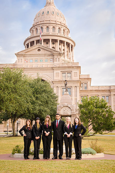Interns posing in front of the Capitol building in Austin