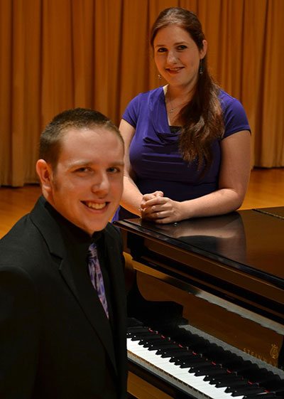 Kirk sitting and Sarah standing by the piano