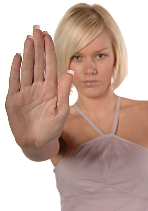 woman holding hand out palm facing camera