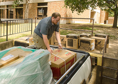 Student unloading boxes