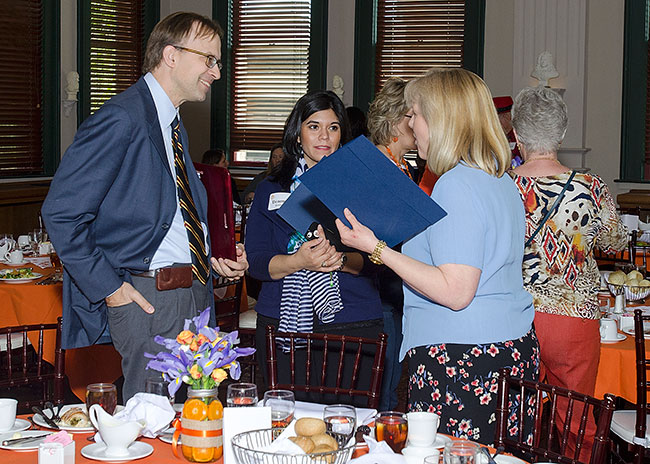 candid photo of luncheon participats talking