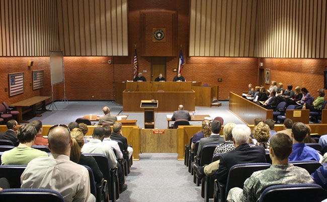 photograph of the courtroom with audience, judges, and jury in attendance
