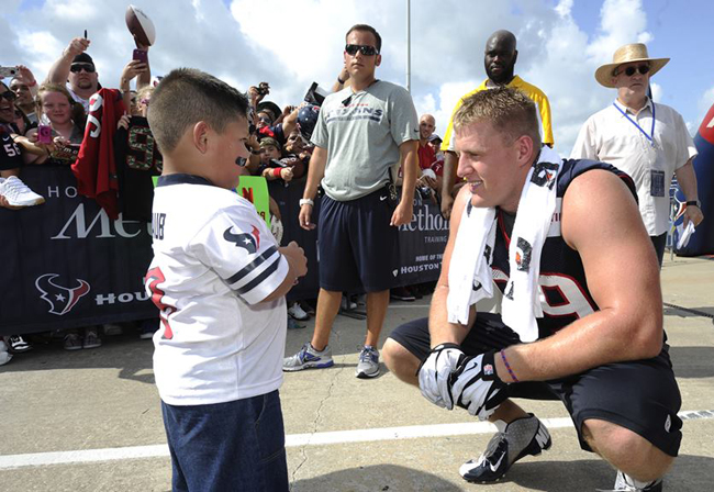 JJ Watt talking to a young Texans fan