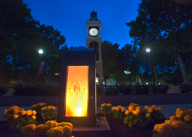 Momument on campus lit at night