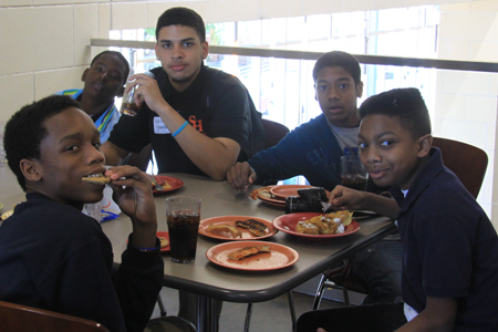 SHSU staff stitting at a table with kids