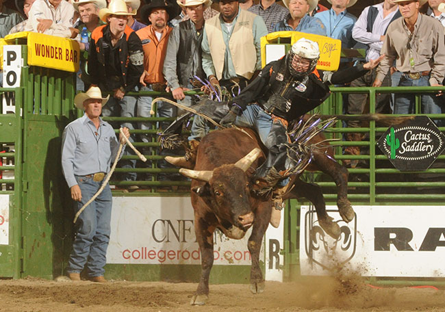 Benton riding a bull