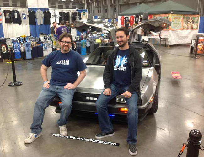 Ernest Cline and Wil Wheaton sitting on Cline's DeLorean