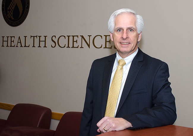 Michael Lacourse posing at desk