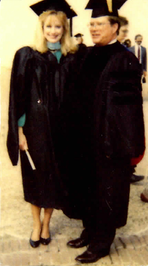 Miller and her father wearing graduation regalia