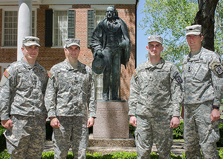 cadets standing in front of Austin Hall and Sam Houston Statue