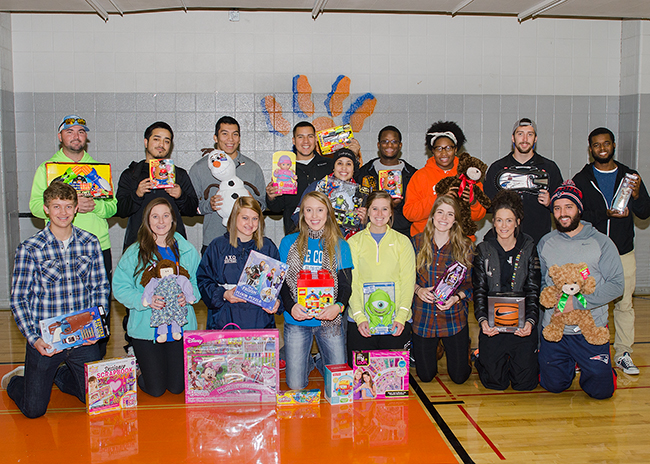 students posing with donated toys
