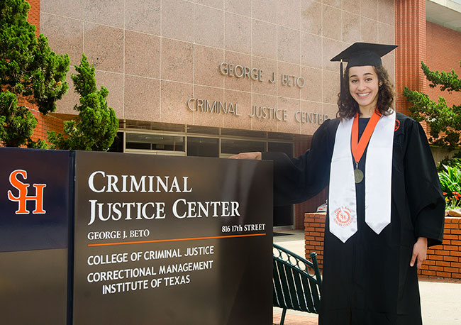 Tipton in cap and gown outside the Criminal Justice Center
