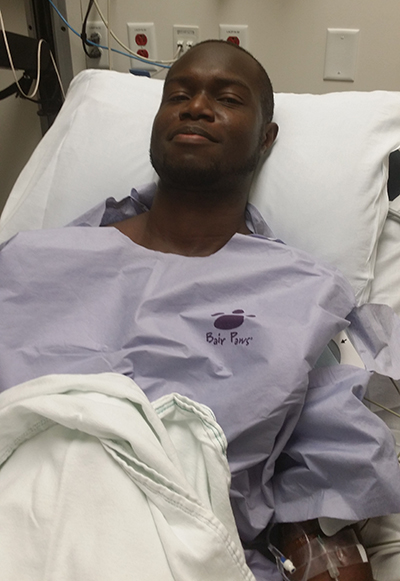 Ade-Kolawole smiling from hospital bed